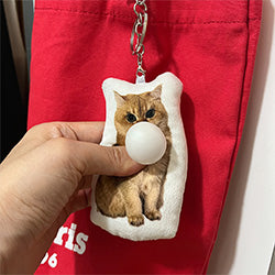 British_shorthair cat Chew Chew Club custom plush keychain with bubble detail attached to a red tote bag