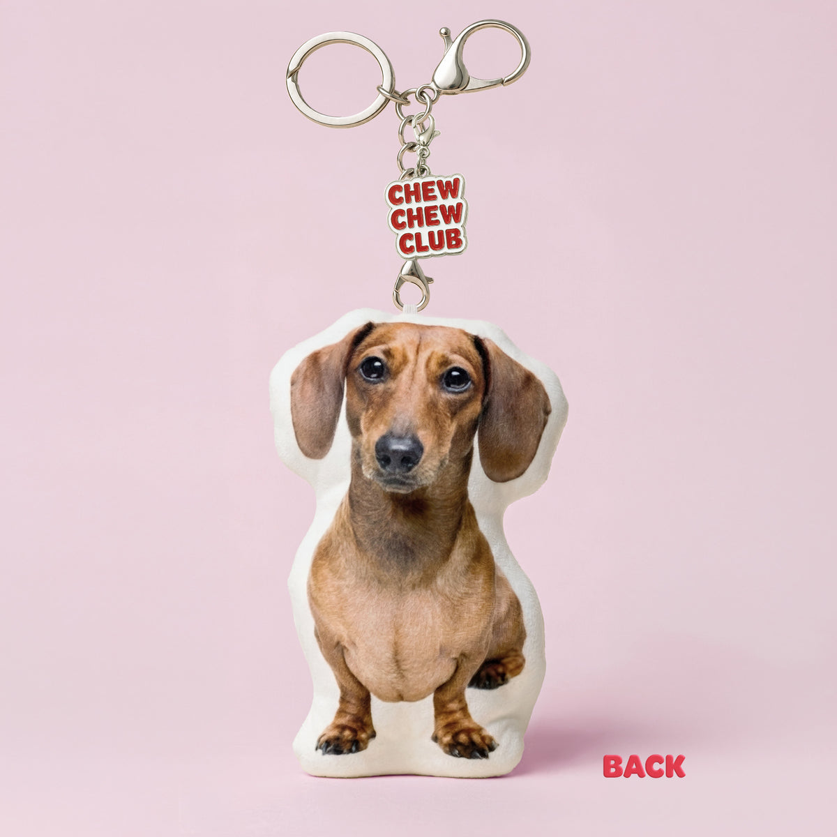 Back of custom Dachshund plush keychain made from a pet photo with Chew Chew Club enamel charm