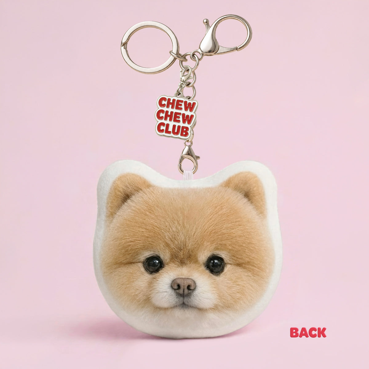 Back of custom Pomeranian dog plush keychain made from a pet photo with Chew Chew Club enamel bag charm