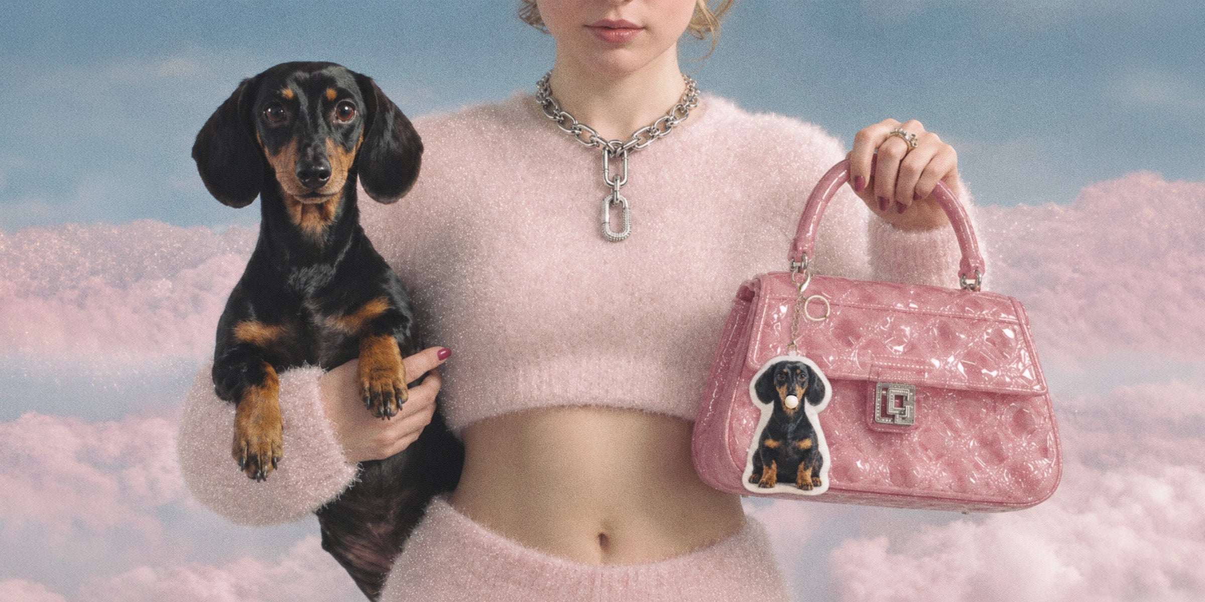 Woman holding black and tan dachshund beside pink handbag with matching custom pet plush keychain charm